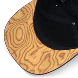 Curved brim baseball style caps made with a real wood brim