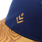 Curved brim baseball style caps made with a real wood brim