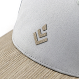 Curved brim baseball style mesh cap made with a real wood brim